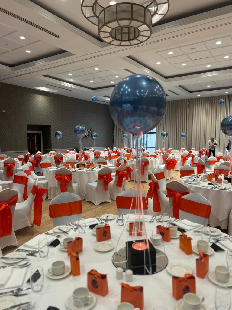 balloon on acrylic legs uplit Spandex chair covers with orange sash Fairways hotel